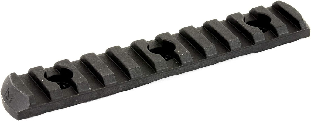 A black textured metal or polymer rail accessory with a series of raised rectangular teeth and circular cutouts, shown on a plain white background.