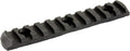 A black textured metal or polymer rail accessory with a series of raised rectangular teeth and circular cutouts, shown on a plain white background.