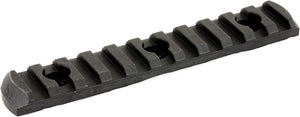 A black textured metal or polymer rail accessory with a series of raised rectangular teeth and circular cutouts, shown on a plain white background.